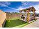 Entertainer's backyard featuring a custom putting green and covered seating area at 129 Barton Bay Ave, North Las Vegas, NV 89031
