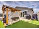 Entertainer's backyard featuring a custom putting green and covered seating area with gas grill at 129 Barton Bay Ave, North Las Vegas, NV 89031