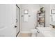 Modern bathroom featuring a glass-enclosed shower and floating shelves for storage at 129 Barton Bay Ave, North Las Vegas, NV 89031