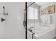 Bright bathroom featuring a soaking tub with shower and elegant tilework at 129 Barton Bay Ave, North Las Vegas, NV 89031