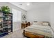 Bright bedroom featuring a comfortable bed, desk, and shelves for storage and decor at 129 Barton Bay Ave, North Las Vegas, NV 89031