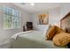 Comfortable bedroom with a decorative headboard, a large window, and a serene atmosphere at 129 Barton Bay Ave, North Las Vegas, NV 89031