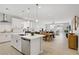 Bright, modern kitchen with white cabinets, stainless steel appliances, and an open floor plan at 129 Barton Bay Ave, North Las Vegas, NV 89031