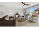 Cozy living room with stylish furniture, a ceiling fan, and sliding glass doors to the patio at 129 Barton Bay Ave, North Las Vegas, NV 89031