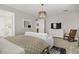 Bright main bedroom features a ceiling fan, TV, rocking chair, and access to an ensuite bathroom at 129 Barton Bay Ave, North Las Vegas, NV 89031