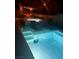 Tranquil pool area at night, featuring lounge chairs and a covered gazebo for relaxation at 129 Barton Bay Ave, North Las Vegas, NV 89031