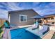 Inviting backyard pool with lounge chairs and umbrella, perfect for relaxation and entertainment at 129 Barton Bay Ave, North Las Vegas, NV 89031