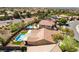 A high-angle aerial view of a home showcases the beautiful pool and landscaped backyard in a suburban neighborhood at 1387 Minuet St, Henderson, NV 89052