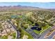 Stunning aerial view showcases a lush community with ponds, a golf course, and mountain views in the background at 1387 Minuet St, Henderson, NV 89052
