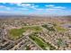 Scenic aerial view featuring a suburban community, sports fields, and the desert landscape in the distance at 1387 Minuet St, Henderson, NV 89052