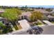 Aerial view of a charming single-story home with lush landscaping and a long driveway in a peaceful neighborhood at 1387 Minuet St, Henderson, NV 89052