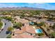 Aerial view showcasing the property, including the pool and the surrounding neighborhood with mountain views in the distance at 1387 Minuet St, Henderson, NV 89052