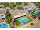 Aerial view of an outdoor oasis featuring a modern pool, hot tub, covered patio, and meticulously landscaped backyard at 1387 Minuet St, Henderson, NV 89052