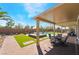 Serene backyard featuring a covered patio, manicured lawn and a pool at 1387 Minuet St, Henderson, NV 89052