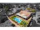 Aerial view showcases a luxurious backyard with a pool, spa, covered patio, and desert landscaping at 1387 Minuet St, Henderson, NV 89052