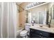 Cozy bathroom featuring a shower/tub combo, black vanity, and neutral paint tones at 1387 Minuet St, Henderson, NV 89052