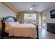 Bedroom with backyard views, featuring wood floors and access to the pool and patio at 1387 Minuet St, Henderson, NV 89052