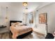 Serene bedroom featuring a queen-sized bed with pastel bedding, modern lighting fixtures, and a bright window at 1387 Minuet St, Henderson, NV 89052
