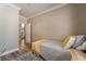 Neutral-toned bedroom featuring stylish bedding and wood-look floors at 1387 Minuet St, Henderson, NV 89052