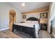 Comfortable bedroom featuring an ensuite bath, wood floors, decorative molding, and natural light at 1387 Minuet St, Henderson, NV 89052