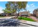 Lovely home featuring desert landscaping with mature shade trees at 1387 Minuet St, Henderson, NV 89052