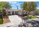 Attractive one-story home featuring a three car garage, low maintenance landscaping, and a circular driveway at 1387 Minuet St, Henderson, NV 89052