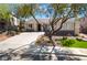 Inviting single-story home features a large front yard with mature trees and a spacious driveway at 1387 Minuet St, Henderson, NV 89052