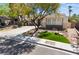 Charming single-story home with well-maintained front yard, mature trees, and a long driveway at 1387 Minuet St, Henderson, NV 89052