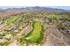 High angle displays lush green golf course with bunkers surrounded by homes in an upscale residential community at 1387 Minuet St, Henderson, NV 89052