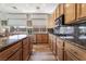Spacious kitchen boasting granite counters, wooden cabinetry, stainless steel appliances, and a functional layout at 1387 Minuet St, Henderson, NV 89052