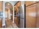 Kitchen showcases stainless refrigerator, ovens, wood cabinets providing ample storage, and granite counters at 1387 Minuet St, Henderson, NV 89052