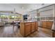 Open-concept kitchen flows into the living area, complete with an island, stainless appliances, and wood cabinets at 1387 Minuet St, Henderson, NV 89052