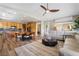 Open-concept space featuring a modern kitchen with wood cabinets, a dining area, and comfortable living room furniture at 1387 Minuet St, Henderson, NV 89052