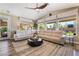 Cozy living room with a comfortable white sofa, stylish coffee table, and large windows offering natural light at 1387 Minuet St, Henderson, NV 89052