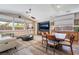 Inviting living room with a comfortable white sofa, dining table, and an entertainment center with a modern TV at 1387 Minuet St, Henderson, NV 89052