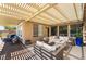 Inviting outdoor patio with comfortable seating and a built-in fire feature at 1387 Minuet St, Henderson, NV 89052
