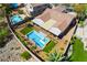 Aerial view highlights a backyard oasis with a sparkling pool, spa, shaded patio, and desert-friendly landscaping at 1387 Minuet St, Henderson, NV 89052