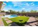 Backyard with a pristine pool, spa, and lush landscaping at 1387 Minuet St, Henderson, NV 89052