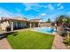 Backyard with a pristine pool, spa, and lush landscaping at 1387 Minuet St, Henderson, NV 89052