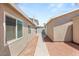 Exterior view of the backyard showcasing the walkway, and surrounding landscaping at 1505 Irene Dr, Boulder City, NV 89005