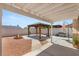 Outdoor living in backyard with covered patio, pergola, gravel, and a built-in fire pit at 1505 Irene Dr, Boulder City, NV 89005