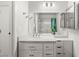 Bright bathroom featuring a marble countertop vanity, framed mirror, and modern vanity lights at 1505 Irene Dr, Boulder City, NV 89005