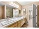 Spacious bathroom with double vanity, large mirror, and tiled shower at 1505 Irene Dr, Boulder City, NV 89005