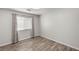Neutral bedroom with wood floors, natural light, and blinds for customizable privacy at 1505 Irene Dr, Boulder City, NV 89005