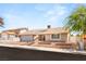Charming one-story home with a desert landscape, attached garage, and tile roof at 1505 Irene Dr, Boulder City, NV 89005