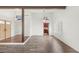 Spacious living room with wood-look floors, beams, and ample natural light from shuttered windows at 1505 Irene Dr, Boulder City, NV 89005