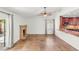 Open floorplan with fireplace, ceiling fan and tile flooring that connects the living room and kitchen at 1505 Irene Dr, Boulder City, NV 89005