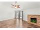 The living room features tile flooring, a ceiling fan, a stone fireplace, and access to the backyard at 1505 Irene Dr, Boulder City, NV 89005