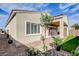 A covered patio and synthetic grass with pavers extend from the home at 161 Cabo Cruces Dr, Henderson, NV 89011
