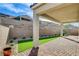 Paver patio with artificial turf and block wall in a well maintained backyard at 161 Cabo Cruces Dr, Henderson, NV 89011